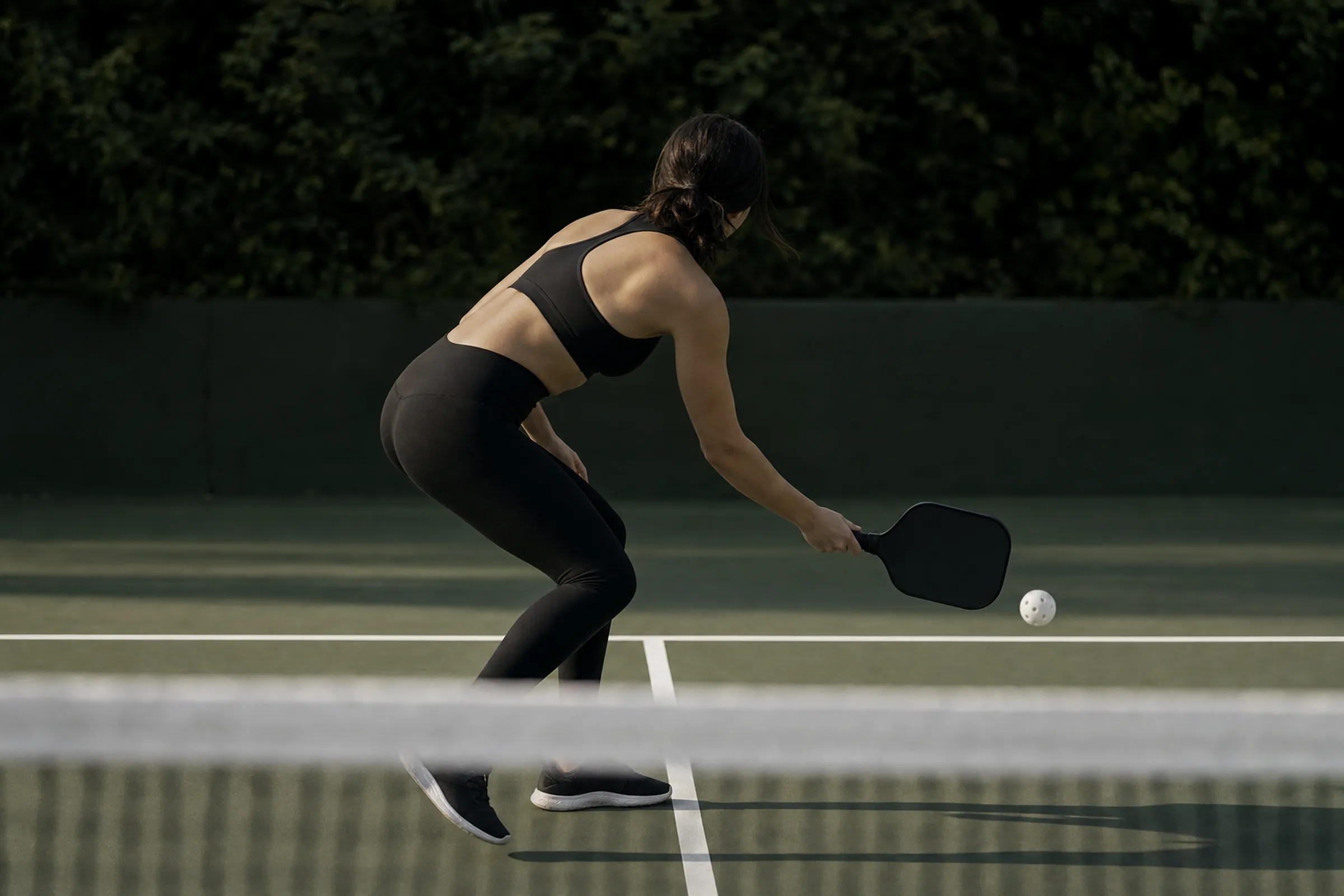 A player at the kitchen line in black leggings and a sports bra